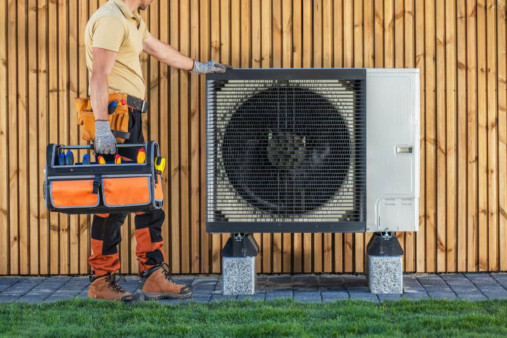 HVAC Technician Standing by AC Unit