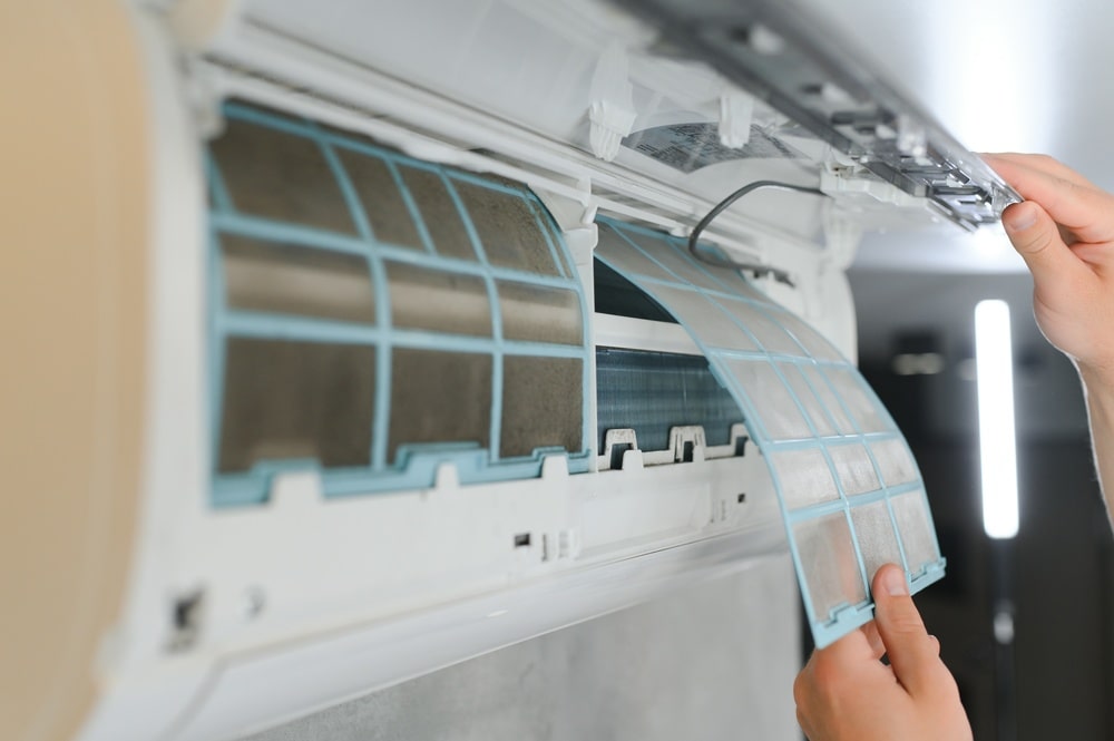 Service Man Cleaning Air Conditioner
