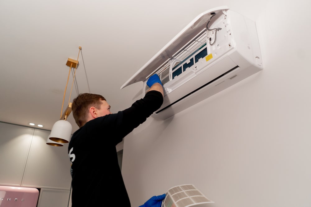technician cleaning ac filter