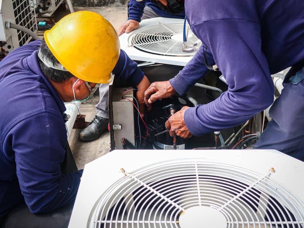 Technician Repairs Air Conditioner