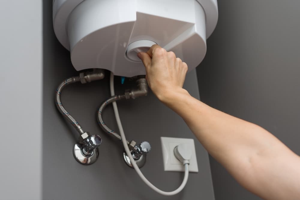 woman hands setting water heater