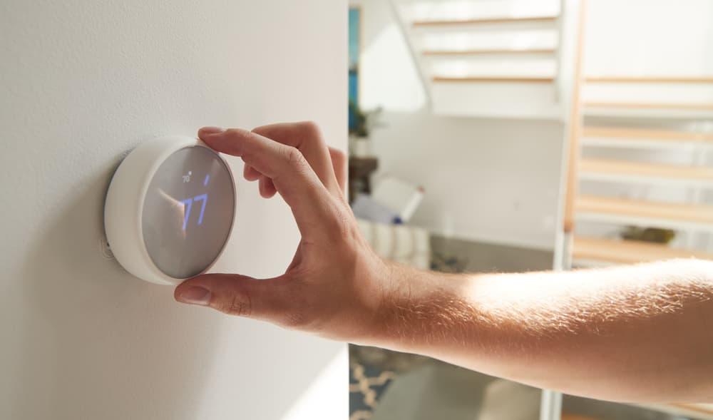 Technician Adjusting Digital Central Thermostat