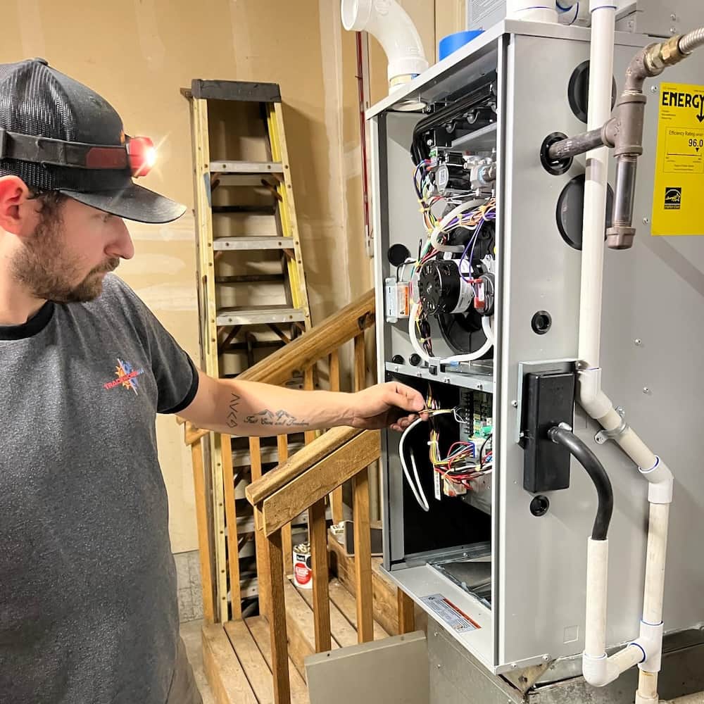 Technician checking furnace for issues
